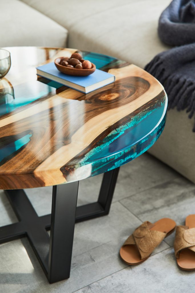 Stylish composition with design epoxy coffee table, sofa, blanke